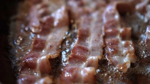 Bacon cooking in a pan close up Video stock 104659277