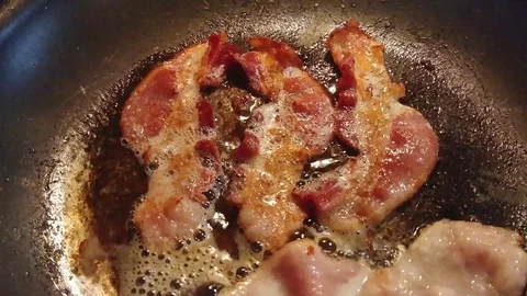 Bacon Cooking in a Pan - Sizzling - with audio Stock Footage 129046577