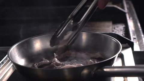 Bacon cooking slowmo on a pan Stock Footage 89202382