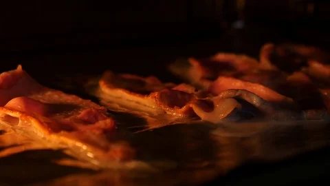 Bacon cooking under a grill/broiler Stock Footage 101284380