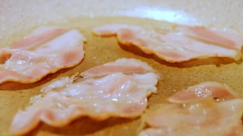 Bacon cooking on a white hot pan Stock Footage 100684618