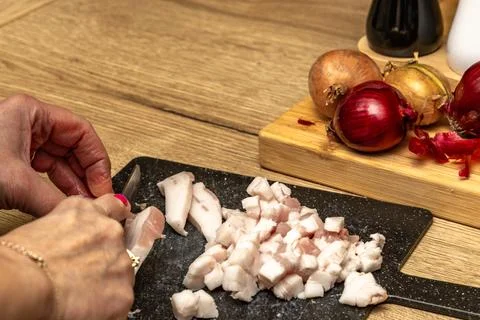Bacon cut into thin pieces, bacon cubes, preparing ingredients for lard in .. Stock Photos