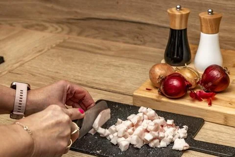 Bacon cut into thin pieces, bacon cubes, preparing ingredients for lard in .. Stock Photos