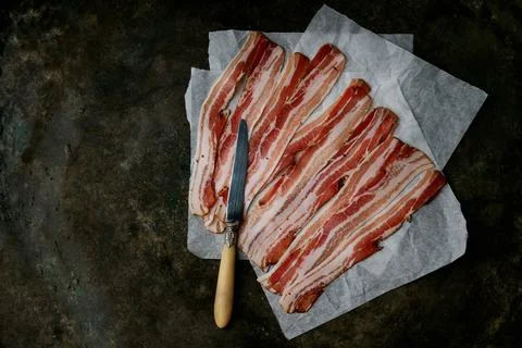 Bacon on a dark rustic background Stock Photos