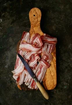 Bacon on a dark rustic background Stock Photos