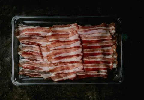 Bacon on a dark rustic background Stock Photos