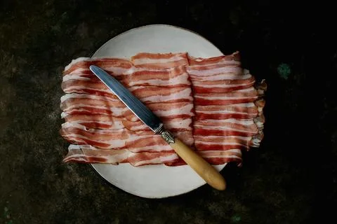 Bacon on a dark rustic background Stock Photos