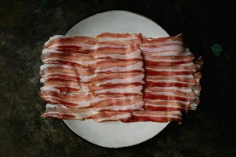 Bacon on a dark rustic background Stock Photos