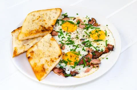 Bacon, eggs and chive with crispy toast Stock Photos