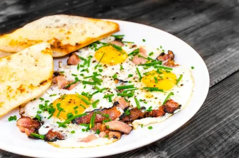 Bacon, eggs and chive with crispy toast Stock Photos