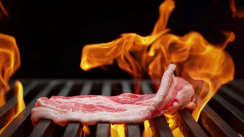Bacon Falling onto Grill Grate in Slow Motion - Barbecue on Black Background 스톡 동영상 196876781