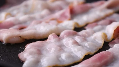 Bacon is fried in a frying pan Stock Footage 176390251