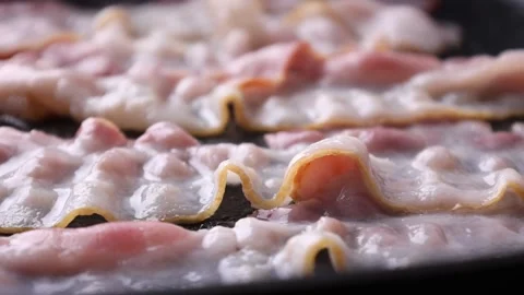 Bacon is fried in a frying pan Stock Footage 176390259
