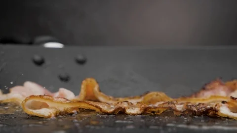 The bacon is fried in a pan. Stock Footage 117037479