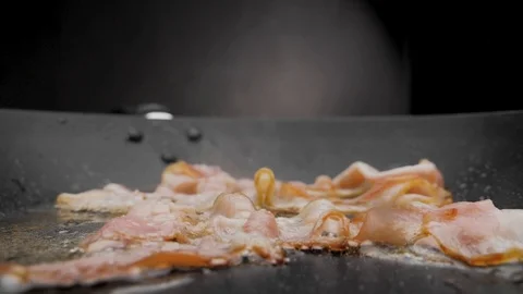 The bacon is fried in a pan. Stock Footage 117037623