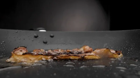 The bacon is fried in a pan. Stock Footage 117517833