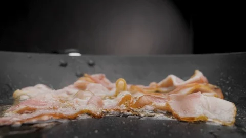 The bacon is fried in a pan. Stock Footage 117518011