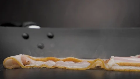 The bacon is fried in a pan. Stock Footage 117778865