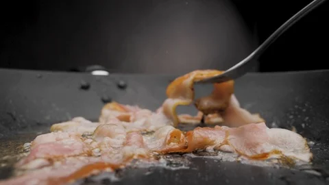 The bacon is fried in a pan. Stock-Footage 117778986