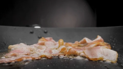 The bacon is fried in a pan. Stock-Footage 119453539