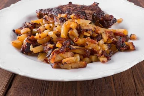 Bacon with fried potatoes Stock Photos
