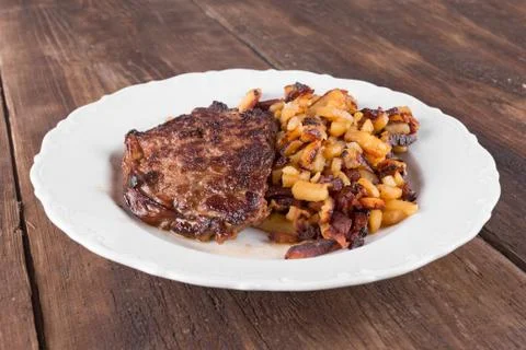 Bacon with fried potatoes Stock Photos