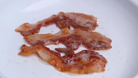 Bacon fried in a white frying pan Stock Footage 276293628