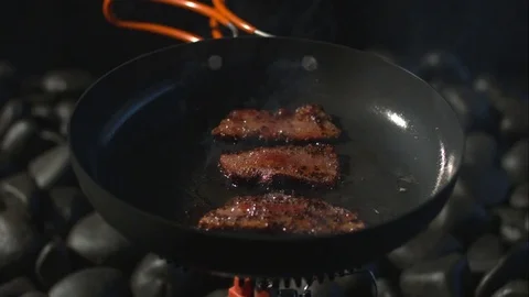 Bacon frying close up slow motion Stock Footage 77688873