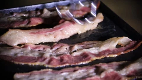 Bacon frying on a grill Stock Footage 144034744