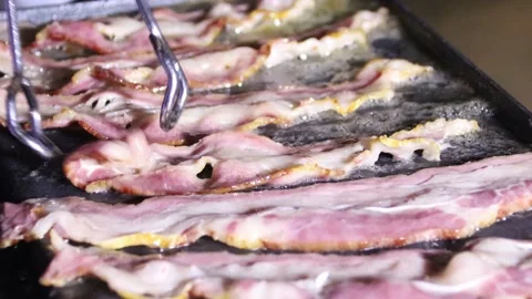 Bacon frying on a grill Stock Footage 144034818