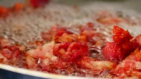 Bacon frying in the pan with the boiling oil make colorful tasty bacon. Видео 79609248