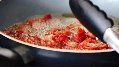 Bacon frying in the pan with the boiling oil make colorful tasty bacon. Video stock 79609343
