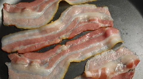 Bacon frying in a pan Stock Footage 67948068