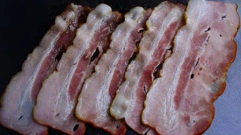 Bacon frying in a pan Stock Footage 75438104