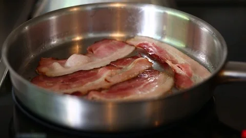 Bacon frying in a pan Video stock 97440614