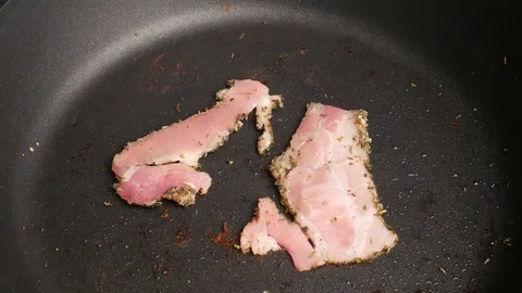 Bacon frying in a pan. Time lapse. Stock Footage 70878938