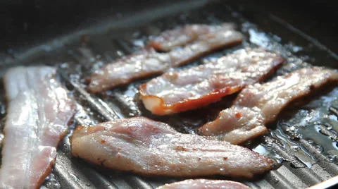 Bacon in hot non-stick pan Stock Footage 33743119