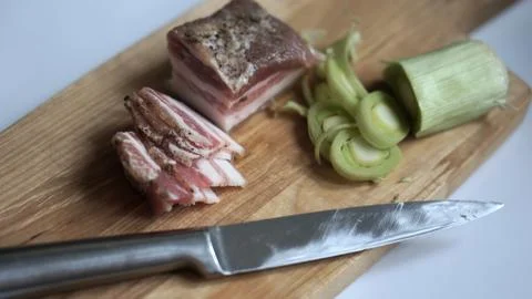 Bacon, leeks, black bread and a knife Stock Photos