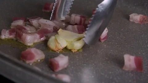 Bacon pancetta roasting/frying with garlic Stock Footage 123800613