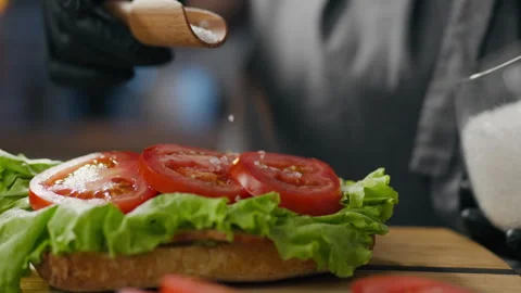 Bacon, a professional chef cooks confidently Salt vegetables cooking process Stock Footage 246210467