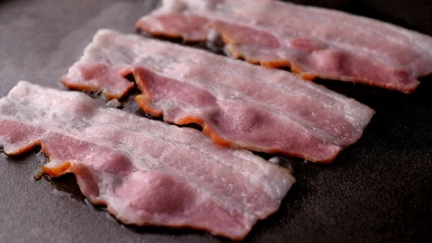Bacon rotation in slow motion. Cooking bacon on grill - Video 4K Stock Footage 128406384