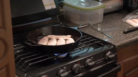 Bacon Sizzles on Cast Iron Skillet in 5th Wheel RV Stock Footage