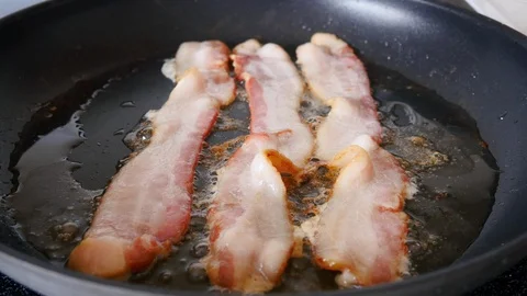 Bacon Sizzling in a Frying Pan Stock Footage 130159528