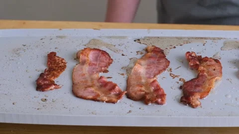 Bacon sizzling on a griddle. Stock Footage 138332253