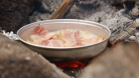 Bacon Sizzling On Open Fire While Camping Close Up Stock-Footage 102141572