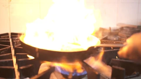 Bacon sizzling in a pan, with fire Stock Footage 98239170