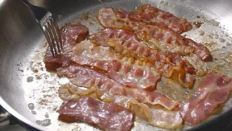 Bacon slice being cooked in frying pan. Close up. Stock Footage 122834926