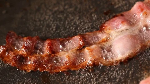 Bacon slice frying on pan in sunflower oil Stock Footage 82739477