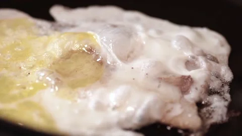 Bacon slices, egg are fried on the stove. Greens, parsley, dill fall from above Stock Footage 146336089