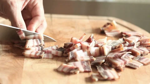 Bacon slicing and moving away from chopping board Stock Footage 35892987